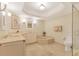 Elegant bathroom featuring double vanity, marble floors, soaking tub, and separate shower at 1800 Benjamin Franklin Dr # B310, Sarasota, FL 34236