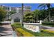 Elegance Condo community entrance with lush landscaping and brick paved drive at 1800 Benjamin Franklin Dr # B310, Sarasota, FL 34236