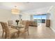 Dining area with glass table, comfortable seating, tile floors, and an ocean view at 1800 Benjamin Franklin Dr # B310, Sarasota, FL 34236