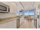 Modern kitchen with stainless steel appliances and ocean view at 1800 Benjamin Franklin Dr # B310, Sarasota, FL 34236