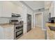 Well-equipped kitchen with white cabinetry, stainless steel appliances, and ample counter space at 1800 Benjamin Franklin Dr # B310, Sarasota, FL 34236