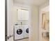 This spacious laundry room is equipped with a washer and dryer, plus plenty of storage at 1800 Benjamin Franklin Dr # B310, Sarasota, FL 34236