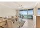 Bright living room with ocean views from sliding glass door leading to balcony at 1800 Benjamin Franklin Dr # B310, Sarasota, FL 34236