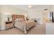 Main bedroom featuring large bed, tile flooring, and ocean view at 1800 Benjamin Franklin Dr # B310, Sarasota, FL 34236