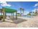 Enjoy community pool with ocean views from this shaded lounge area with table and chairs at 1800 Benjamin Franklin Dr # B310, Sarasota, FL 34236