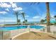 Enjoy breathtaking ocean views from this community pool with palm trees and lounge chairs at 1800 Benjamin Franklin Dr # B310, Sarasota, FL 34236