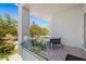 A bright, airy balcony featuring modern furniture, glass railings, and a view of the neighborhood at 1842 Kenilworth St, Sarasota, FL 34231