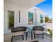 A balcony area features modern outdoor seating, white walls, and clear glass railings at 1842 Kenilworth St, Sarasota, FL 34231