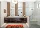 Modern bathroom with double vanity, unique mirrors, and a luxurious glass shower at 1842 Kenilworth St, Sarasota, FL 34231
