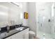 Modern bathroom featuring a sleek vanity, stylish fixtures, and a glass-enclosed shower with marble tile accents at 1842 Kenilworth St, Sarasota, FL 34231