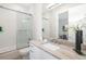 This bathroom boasts a modern vanity, chic decor, and a shower-tub combination with glass sliding doors at 1842 Kenilworth St, Sarasota, FL 34231