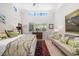 Bright bedroom featuring a sitting area, light hardwood floors, and large windows at 1842 Kenilworth St, Sarasota, FL 34231