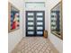 Inviting foyer features modern artwork, a stylish rug, and a sleek double-door entrance at 1842 Kenilworth St, Sarasota, FL 34231