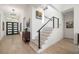 Welcoming foyer with modern staircase, featuring wood steps, black railings, and sleek design at 1842 Kenilworth St, Sarasota, FL 34231