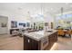 Bright open-concept kitchen with island featuring stainless steel appliances and marble countertops at 1842 Kenilworth St, Sarasota, FL 34231