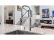 Close-up of a sleek kitchen faucet, complementing the marble countertop and the home's modern design elements at 1842 Kenilworth St, Sarasota, FL 34231