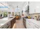Well-lit kitchen showcasing modern cabinetry, stainless steel appliances, and an adjacent dining area at 1842 Kenilworth St, Sarasota, FL 34231