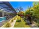 Backyard with tropical landscaping, including plants, trees, and mulch at 1842 Kenilworth St, Sarasota, FL 34231