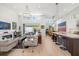 Open concept living room featuring hardwood floors, modern lighting, and fireplace at 1842 Kenilworth St, Sarasota, FL 34231