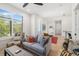 Bright living room with a ceiling fan, modern furniture, and large windows showcasing the outdoor view at 1842 Kenilworth St, Sarasota, FL 34231