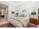A well-decorated main bedroom with large windows and an ensuite bathroom for a functional design at 1842 Kenilworth St, Sarasota, FL 34231