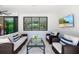 Cozy covered patio featuring comfortable seating, a TV, and sliding doors for indoor/outdoor flow at 1842 Kenilworth St, Sarasota, FL 34231