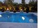 Backyard pool features floating ball lights and elevated fire bowls for nighttime ambiance at 1842 Kenilworth St, Sarasota, FL 34231