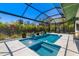 Screened-in pool with attached spa, lush landscaping, and elegant patio design at 1842 Kenilworth St, Sarasota, FL 34231