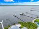 Aerial view of waterfront property with private dock and lush landscaping along the shoreline at 1907 4Th W St, Palmetto, FL 34221