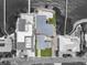 An aerial view outlines a home with private beach area, dock and lush landscaping at 1907 4Th W St, Palmetto, FL 34221