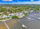 Aerial view of homes with docks, lush landscaping, and serene waterfront, showcasing a beautiful residential area at 1907 4Th W St, Palmetto, FL 34221