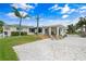 Spacious backyard with a deck, stylish outdoor furniture, and lush landscaping for relaxing or entertaining at 1907 4Th W St, Palmetto, FL 34221