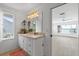 Bright bathroom features custom vanity with stone countertop, lamps, and a waterfront view at 1907 4Th W St, Palmetto, FL 34221