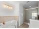 Bright bathroom with a shower, soaking tub, and contemporary fixtures at 1907 4Th W St, Palmetto, FL 34221