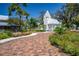 Quaint chapel nestled among trees and greenery, surrounded by brick pathways and colorful flowerbeds at 1907 4Th W St, Palmetto, FL 34221