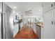Kitchen with terra-cotta tile flooring, modern appliances, and connecting dining area at 1907 4Th W St, Palmetto, FL 34221