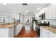Well lit kitchen with modern appliances, granite countertops, and terra-cotta tile floors at 1907 4Th W St, Palmetto, FL 34221