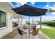 Outdoor dining area with a view of the waterfront, furnished with a table and comfortable seating at 1907 4Th W St, Palmetto, FL 34221