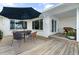 Outdoor patio with dining set, umbrella, and views of the waterfront and porch area at 1907 4Th W St, Palmetto, FL 34221