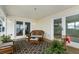 Inviting covered porch featuring wicker furniture, a patterned rug, and double doors leading inside at 1907 4Th W St, Palmetto, FL 34221