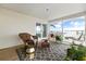 Cozy covered porch with wicker furniture, patterned rug, and scenic waterfront views through the white railing at 1907 4Th W St, Palmetto, FL 34221