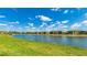 Panoramic view of lake from the lush green lawn of the back yard in this desirable neighborhood at 20398 Lagente Cir, Venice, FL 34293