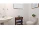 Powder room with pedestal sink, toilet, window, and coastal decor at 20398 Lagente Cir, Venice, FL 34293