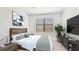 Well-lit bedroom with a bed, wall art, and window at 20398 Lagente Cir, Venice, FL 34293