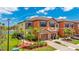 Beautiful two-story townhome with attached garage, landscaping, and view of the lake at 20398 Lagente Cir, Venice, FL 34293