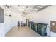 An organized garage with epoxy floor, storage racks, golf clubs, and door to interior of the home at 20398 Lagente Cir, Venice, FL 34293