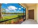 Relax and unwind on this covered patio with a view of the serene lake and community landscaping at 20398 Lagente Cir, Venice, FL 34293