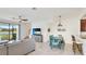 Relaxing living room and dining area with a view of the lake at 20398 Lagente Cir, Venice, FL 34293