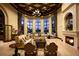 Luxurious living room with a fireplace, large windows, and sophisticated seating arrangement overlooking a water view at 20398 Lagente Cir, Venice, FL 34293
