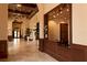 Elegant lobby with travertine floors, coffered ceilings, and stylish reception desk at 20398 Lagente Cir, Venice, FL 34293